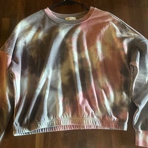 This is a ultra flirt large sweatshirt that has a mix of pink, gray,white colors